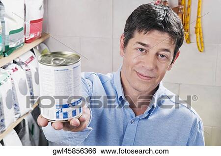 Man buying dog food in a supermarket View Large Photo Image Stock Photograph - Man buying dog food in a supermarket. Fotosearch
