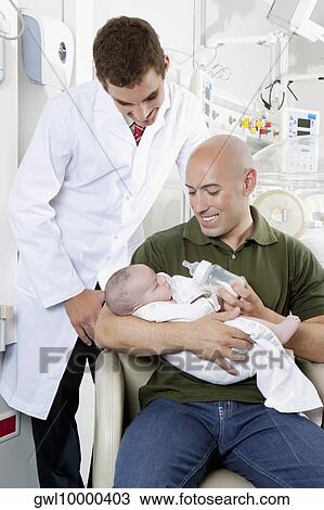 Man carrying his newborn baby View Large Photo Image Stock Image - Man carrying his newborn baby. Fotosearch