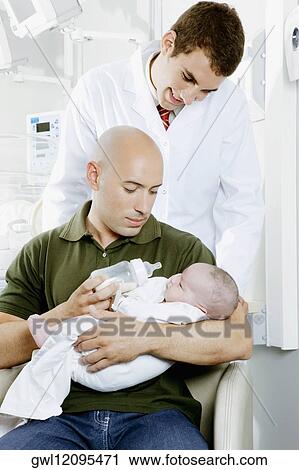 Man carrying his newborn baby View Large Photo Image Stock Image - Man carrying his newborn baby. Fotosearch