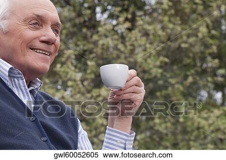 Man drinking tea and smiling View Large Photo Image Stock Photography - Man drinking tea and smiling. Fotosearch
