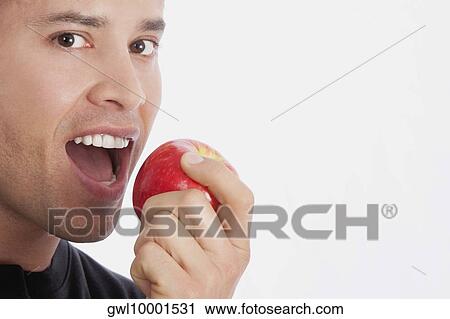 Man eating an apple View Large Photo Image Stock Image - Man eating an apple. Fotosearch