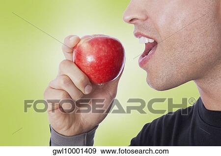 Man eating an apple View Large Photo Image Stock Photo - Man eating an apple. Fotosearch