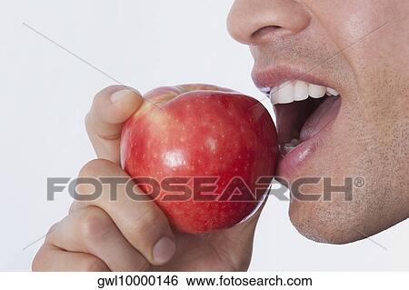 Man eating an apple View Large Photo Image Stock Photograph - Man eating an apple. Fotosearch
