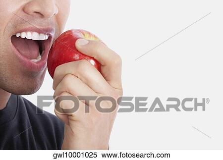 Stock Photography - Man eating an apple. Fotosearch