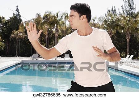 Man exercising at the poolside View Large Photo Image Stock Photography - Man exercising at the poolside. Fotosearch