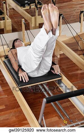 Man exercising in a gym View Large Photo Image Stock Image - Man exercising in a gym. Fotosearch
