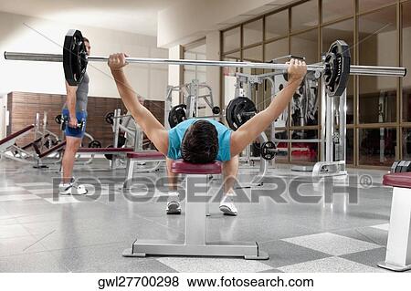 Stock Photo - Man exercising in a gym. Fotosearch