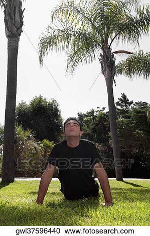 Man exercising in a park View Large Photo Image Stock Image - Man exercising in a park. Fotosearch