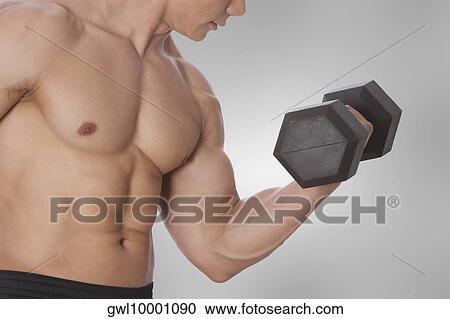 Stock Image - Man exercising with a dumbbell. Fotosearch