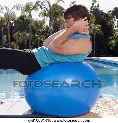 Man exercising with a fitness ball at the poolside View Large Photo Image Stock Image - Man exercising with a fitness ball at the poolside. Fotosearch