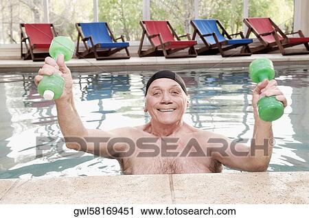 Man exercising with dumbbells in a swimming pool View Large Photo Image Stock Image - Man exercising with dumbbells in a swimming pool. Fotosearch