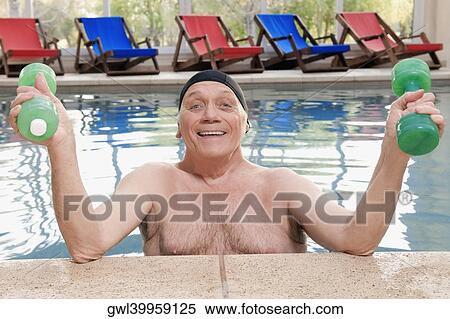 Stock Photography - Man exercising with dumbbells in a swimming pool. Fotosearch