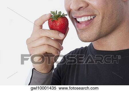 Man holding a strawberry View Large Photo Image Stock Photography - Man holding a strawberry. Fotosearch