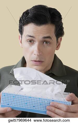 Man holding a tissue paper box View Large Photo Image Picture - Man holding a tissue paper box. Fotosearch