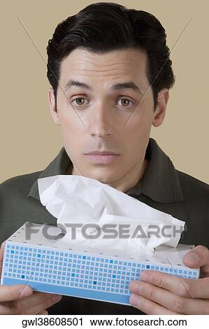 Man holding a tissue paper box View Large Photo Image Stock Image - Man holding a tissue paper box. Fotosearch