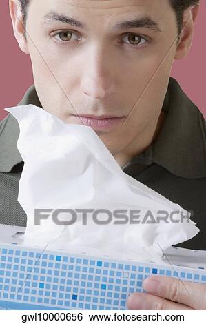 Man holding a tissue paper box View Large Photo Image Stock Photograph - Man holding a tissue paper box. Fotosearch