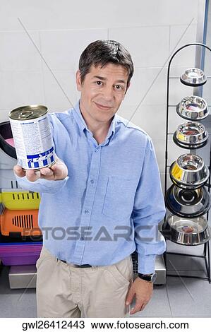 Man holding dog food in a supermarket View Large Photo Image Stock Image - Man holding dog food in a supermarket. Fotosearch
