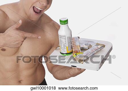Man holding food supplements and laughing View Large Photo Image Stock Photo - Man holding food supplements and laughing. Fotosearch