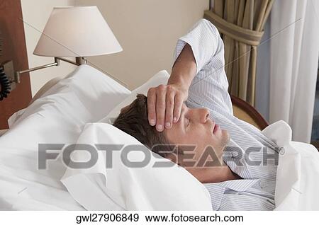 Man lying in a hospital bed View Large Photo Image Stock Photo - Man lying in a hospital bed. Fotosearch