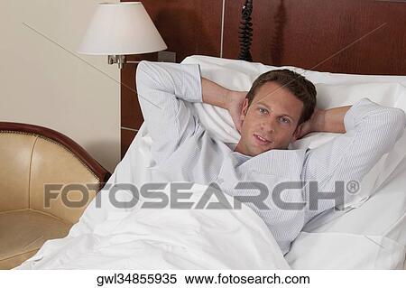 Stock Photography - Man lying in a hospital bed. Fotosearch