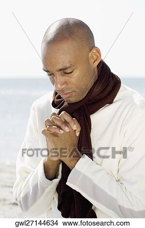 Man meditating on the beach View Large Photo Image Picture - Man meditating on the beach. Fotosearch