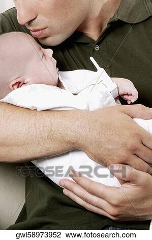 Man pampering his newborn baby View Large Photo Image Stock Image - Man pampering his newborn baby. Fotosearch