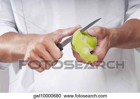 Man peeling a granny smith apple View Large Photo Image Stock Image - Man peeling a granny smith apple. Fotosearch