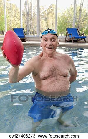 Man playing with a rugby ball in a swimming pool View Large Photo Image Stock Image - Man playing with a rugby ball in a swimming pool. Fotosearch