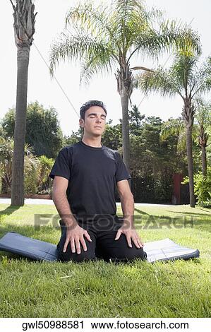 Man practicing yoga in a park View Large Photo Image Stock Image - Man practicing yoga in a park. Fotosearch