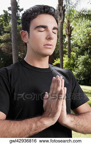 Man practicing yoga in a park View Large Photo Image Stock Photograph - Man practicing yoga in a park. Fotosearch