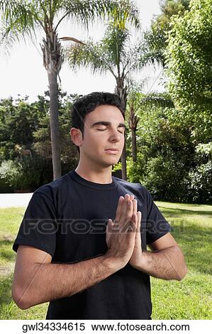 Man practicing yoga in a park View Large Photo Image Stock Photography - Man practicing yoga in a park. Fotosearch