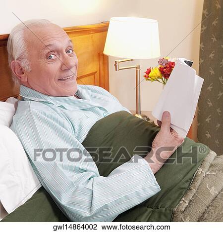 Man reading a book in nursing home and smiling View Large Photo Image Stock Image - Man reading a book in nursing home and smiling. Fotosearch