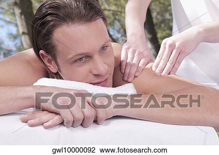 Man receiving back massage from a massage therapist View Large Photo Image Stock Image - Man receiving back massage from a massage therapist. Fotosearch