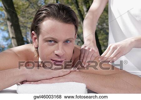 Man receiving back massage from a massage therapist View Large Photo Image Stock Photo - Man receiving back massage from a massage therapist. Fotosearch