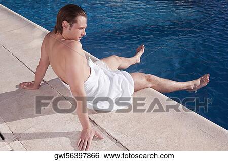 Man resting at the poolside View Large Photo Image Stock Photograph - Man resting at the poolside. Fotosearch