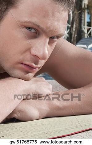 Man resting at the poolside View Large Photo Image Stock Photography - Man resting at the poolside. Fotosearch