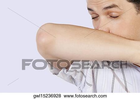 Man rubbing his nose with arm View Large Photo Image Stock Photo - Man rubbing his nose with arm. Fotosearch