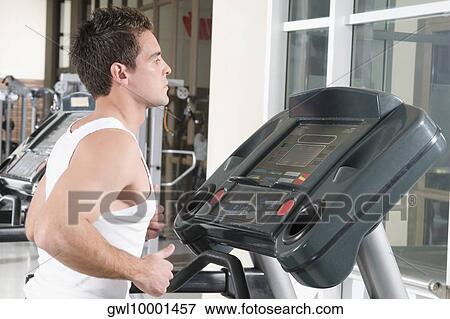 Stock Photo - Man running on a treadmill. Fotosearch