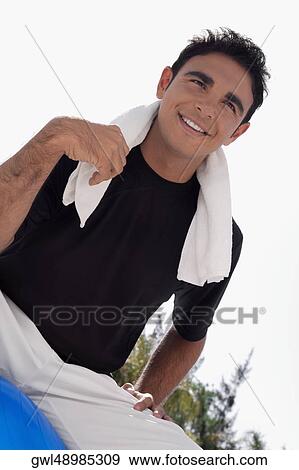 Man sitting on a fitness ball and smiling View Large Photo Image Stock Photo - Man sitting on a fitness ball and smiling. Fotosearch