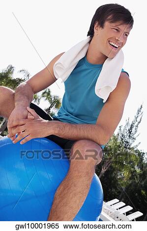 Man sitting on a fitness ball and laughing View Large Photo Image Stock Photography - Man sitting on a fitness ball and laughing. Fotosearch