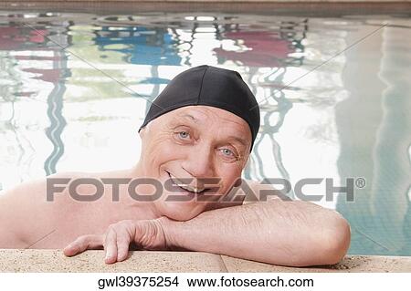 Man smiling in a swimming pool View Large Photo Image Picture - Man smiling in a swimming pool. Fotosearch