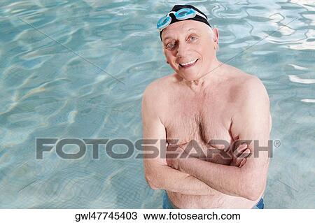 Man smiling in a swimming pool with his arms crossed View Large Photo Image Stock Image - Man smiling in a swimming pool with his arms crossed. Fotosearch