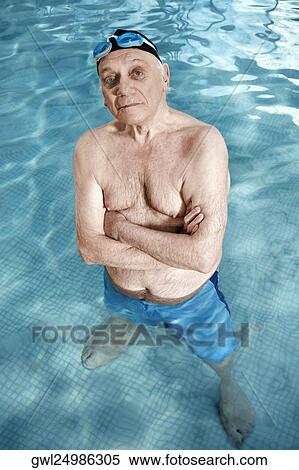 Man standing in a swimming pool with his arms crossed View Large Photo Image Stock Photography - Man standing in a swimming pool with his arms crossed. Fotosearch