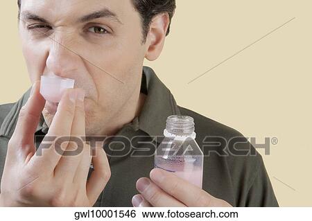 Man taking medicine and making a face View Large Photo Image Stock Photograph - Man taking medicine and making a face. Fotosearch