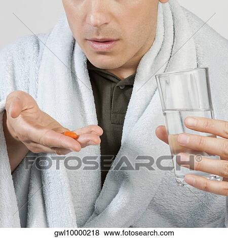 Man taking medicine View Large Photo Image Stock Photo - Man taking medicine. Fotosearch