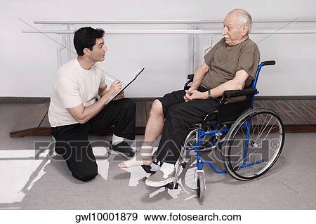 Man updating the medical records of patient View Large Photo Image Stock Photo - Man updating the medical records of patient. Fotosearch