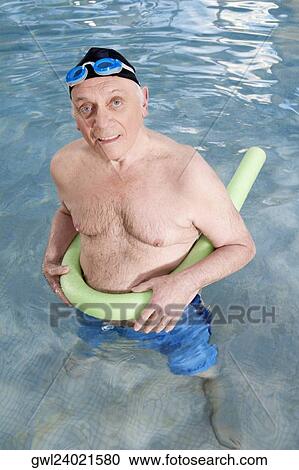 Man using a pool float in a swimming pool View Large Photo Image Stock Image - Man using a pool float in a swimming pool. Fotosearch