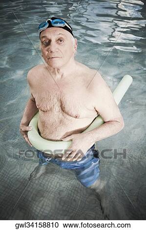 Man using a pool float in a swimming pool View Large Photo Image Stock Image - Man using a pool float in a swimming pool. Fotosearch