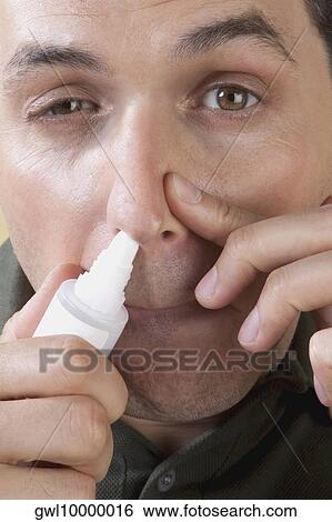 Man using nasal spray View Large Photo Image Stock Photograph - Man using nasal spray. Fotosearch