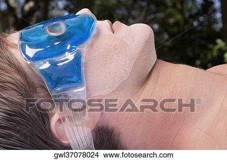 Picture - Man wearing eye mask. Fotosearch
